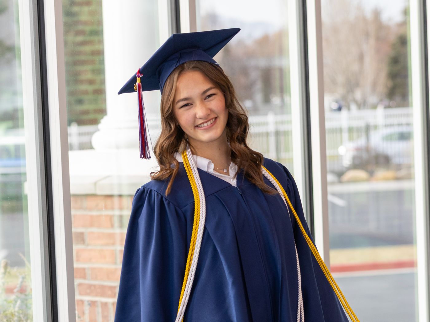 An American Heritage School senior in her cap, gown and honor cords